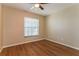 Simple bedroom with wood-look floors and ceiling fan at 3720 Orangepointe Rd, Valrico, FL 33596
