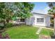 Large backyard with patio, grass, and mature trees at 3720 Orangepointe Rd, Valrico, FL 33596