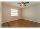 Simple bedroom with wood-look floors and ceiling fan at 3720 Orangepointe Rd, Valrico, FL 33596