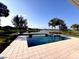 Beautiful pool and lake views in the backyard of this luxurious home at 8904 Bernini Pl, Sarasota, FL 34240