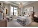 Bright and airy main bedroom with sitting area and golf course views at 8904 Bernini Pl, Sarasota, FL 34240