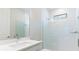 Bright bathroom features a glass-enclosed shower, modern vanity, and neutral finishes at 18324 Rockport Pl, Lakewood Ranch, FL 34211