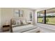Bright bedroom with large window, neutral decor, and comfortable bed at 18324 Rockport Pl, Lakewood Ranch, FL 34211