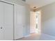 Bedroom with double door closet and access to another room at 18324 Rockport Pl, Lakewood Ranch, FL 34211