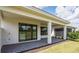 Covered patio with sliding glass doors and view of backyard at 18324 Rockport Pl, Lakewood Ranch, FL 34211