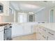 Open concept kitchen with white cabinets and large island at 18324 Rockport Pl, Lakewood Ranch, FL 34211