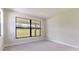 Spacious bedroom with large window offering backyard views at 18324 Rockport Pl, Lakewood Ranch, FL 34211
