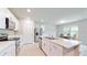 Modern kitchen with white cabinets, island, and stainless steel appliances at 108 Castile Ct, Punta Gorda, FL 33983