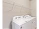Laundry room with Whirlpool washer and dryer, and shelving at 108 Castile Ct, Punta Gorda, FL 33983