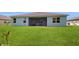Home's exterior showcasing a large backyard and screened patio at 108 Castile Ct, Punta Gorda, FL 33983