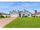 Newly built home with light blue exterior and brick driveway at 108 Castile Ct, Punta Gorda, FL 33983