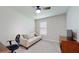 Bedroom with sofa, TV, and home office setup at 108 Castile Ct, Punta Gorda, FL 33983