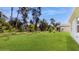 Large backyard with lush grass and mature trees at 108 Castile Ct, Punta Gorda, FL 33983