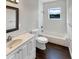 Bathroom with white vanity, tub, and dark hardwood floor at 4719 Chancellor Ne St, St Petersburg, FL 33703