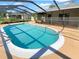 Inviting kidney-shaped pool with a screened enclosure at 2062 Cottondale Ave, Spring Hill, FL 34608