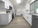 Modern kitchen with white cabinets and stainless steel appliances at 790 Harvard St, Englewood, FL 34223