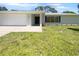 Newly renovated home with attached garage and manicured lawn at 790 Harvard St, Englewood, FL 34223