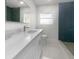Modern bathroom with white vanity, quartz countertop, and green tile shower at 790 Harvard St, Englewood, FL 34223