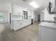 Remodeled kitchen with white cabinets, quartz countertops, and modern appliances at 790 Harvard St, Englewood, FL 34223