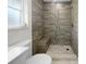 Modern shower with gray tile and built-in bench at 790 Harvard St, Englewood, FL 34223