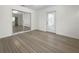Bright bedroom with wood-look floors, sliding mirrored closet doors, and exterior access at 790 Harvard St, Englewood, FL 34223