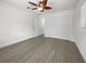 Well-lit bedroom featuring wood-look floors and ample closet space at 790 Harvard St, Englewood, FL 34223