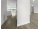 Light and bright hallway with wood-look floors, leading to kitchen and living areas at 790 Harvard St, Englewood, FL 34223