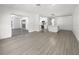 Bright and spacious living area with wood-look flooring and access to the kitchen at 790 Harvard St, Englewood, FL 34223