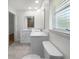 Bathroom with white cabinets, quartz countertop, and double sinks at 790 Harvard St, Englewood, FL 34223