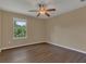 Simple bedroom with wood-look floors and window at 12302 Fairlawn Dr, Riverview, FL 33579