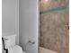 Bathroom with toilet and walk-in shower with pebble floor at 82 Fairway Rd, Rotonda West, FL 33947