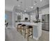 Modern kitchen with white cabinets, stainless steel appliances, and island seating at 82 Fairway Rd, Rotonda West, FL 33947