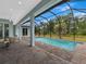 Spacious patio with pool and view of surrounding nature at 82 Fairway Rd, Rotonda West, FL 33947