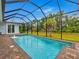 Inviting screened pool with a fountain feature at 82 Fairway Rd, Rotonda West, FL 33947