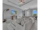 Comfortable living room featuring a large sectional sofa, rug, and access to the dining and entry areas at 82 Fairway Rd, Rotonda West, FL 33947
