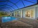Lighted pool and patio at dusk, offering tranquility at 82 Fairway Rd, Rotonda West, FL 33947