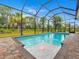 Relaxing screened-in pool with a water feature at 82 Fairway Rd, Rotonda West, FL 33947