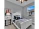 Bright bedroom featuring a white bed frame and wood-look floors at 82 Fairway Rd, Rotonda West, FL 33947