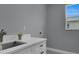 Clean laundry room with white cabinets and a modern sink at 6 Fairway Rd, Rotonda West, FL 33947