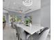 Casual dining area with marble top table and gray chairs near living room at 6 Fairway Rd, Rotonda West, FL 33947