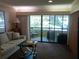 Living room with balcony access and ample natural light at 36750 Us Highway 19 N # 13-216, Palm Harbor, FL 34684
