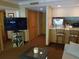 Living room with large TV, comfortable seating, and access to a kitchen at 36750 Us Highway 19 N # 13-216, Palm Harbor, FL 34684