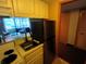 Small kitchen with stainless steel appliances and light cabinets at 36750 Us Highway 19 N # 13-216, Palm Harbor, FL 34684