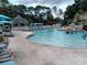 Large community pool with plenty of lounge chairs and a gazebo at 36750 Us Highway 19 N # 13-216, Palm Harbor, FL 34684