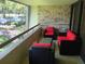 Relaxing balcony with brick wall, seating, and view of surrounding area at 36750 Us Highway 19 N # 13-216, Palm Harbor, FL 34684