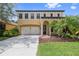 Two-story house with double garage and manicured lawn at 8231 Dunham Station Dr, Tampa, FL 33647
