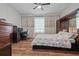 Spacious bedroom with a king bed, built-in workspace, and wood floors at 8231 Dunham Station Dr, Tampa, FL 33647