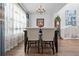 Bright dining room features a chandelier, hardwood floors, and elegant furnishings at 8231 Dunham Station Dr, Tampa, FL 33647