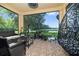 Relaxing screened porch with wicker furniture and view of the backyard at 8231 Dunham Station Dr, Tampa, FL 33647