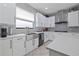 Modern kitchen with white cabinets, stainless steel sink, and subway tile backsplash at 8231 Dunham Station Dr, Tampa, FL 33647